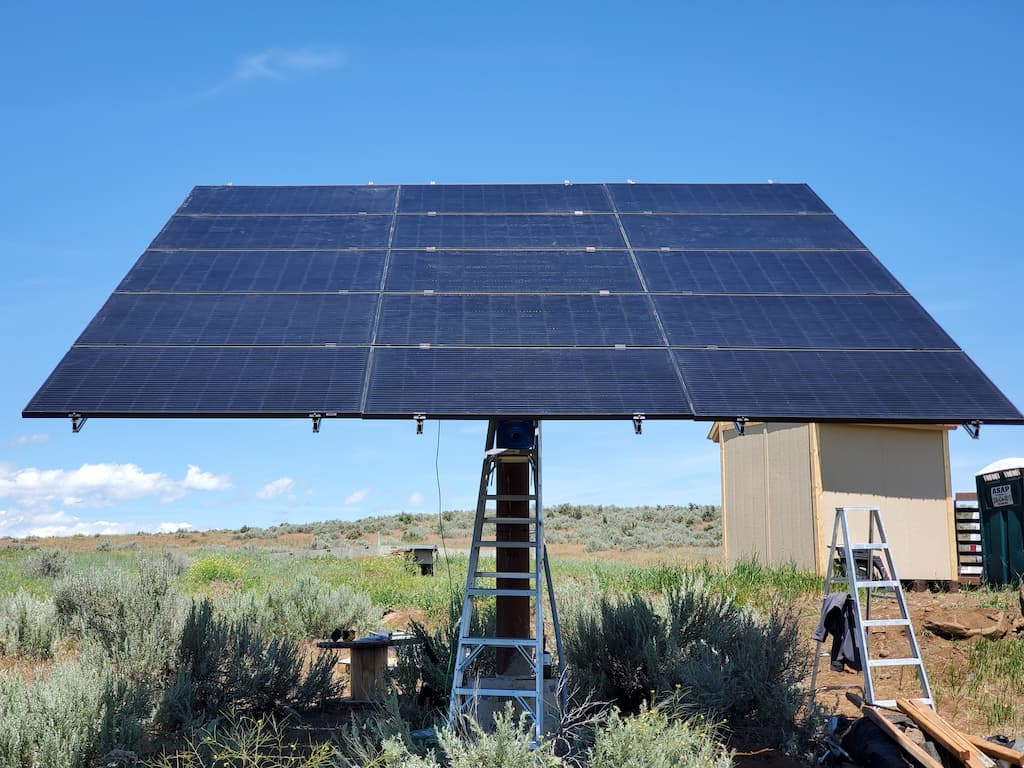 pole mount solar in field next to a shed